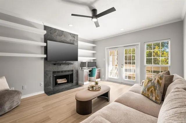 a living room with furniture a flat screen tv and a fireplace