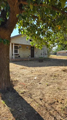 a view of a house with a tree
