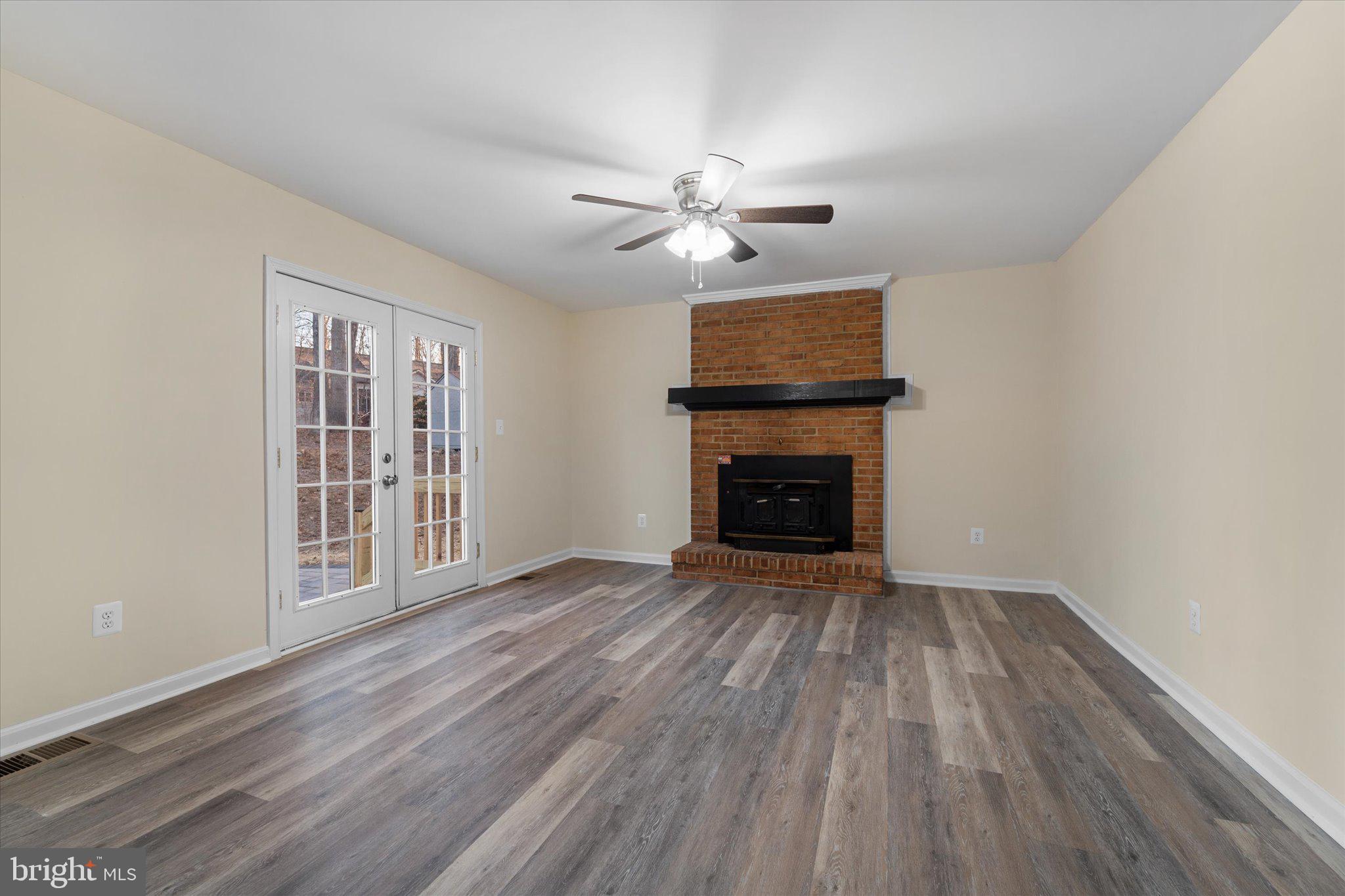 8016 Stillbrooke Road Manassas, VA 20112 - Photo 8 of 41 a view of empty room with wooden floor and fan