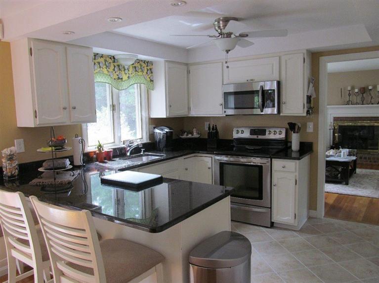 37 Valley Brook Road Centerville, MA 02632 - Photo 3 of 26 a kitchen with stainless steel appliances granite countertop a stove a sink a microwave and a refrigerator