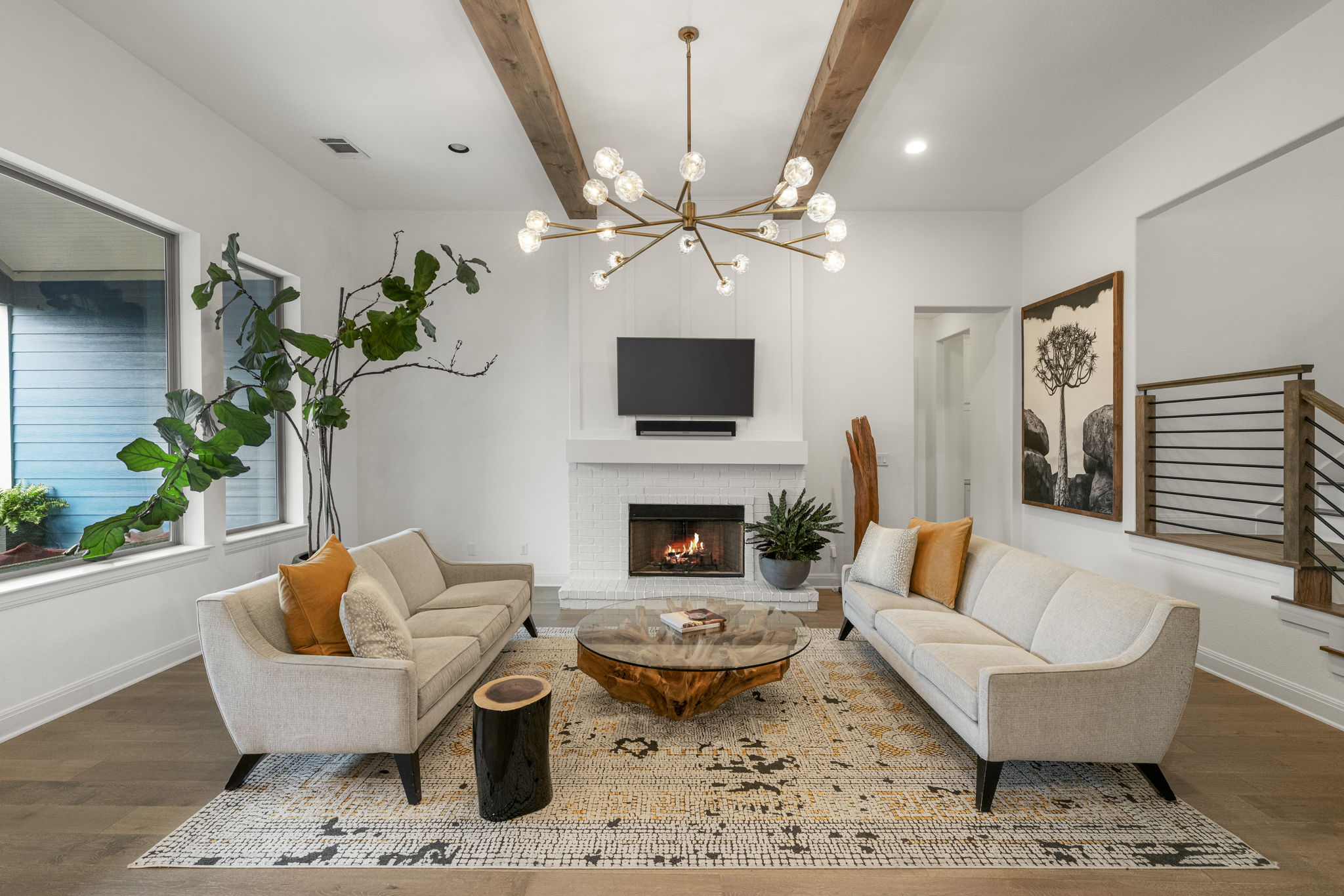 288 Hazy Hills Loop Dripping Springs, TX 78620 - Photo 4 of 40 The main-level living room is anchored by gorgeous beamed ceilings, natural light, and a fireplace that adds warmth and character.