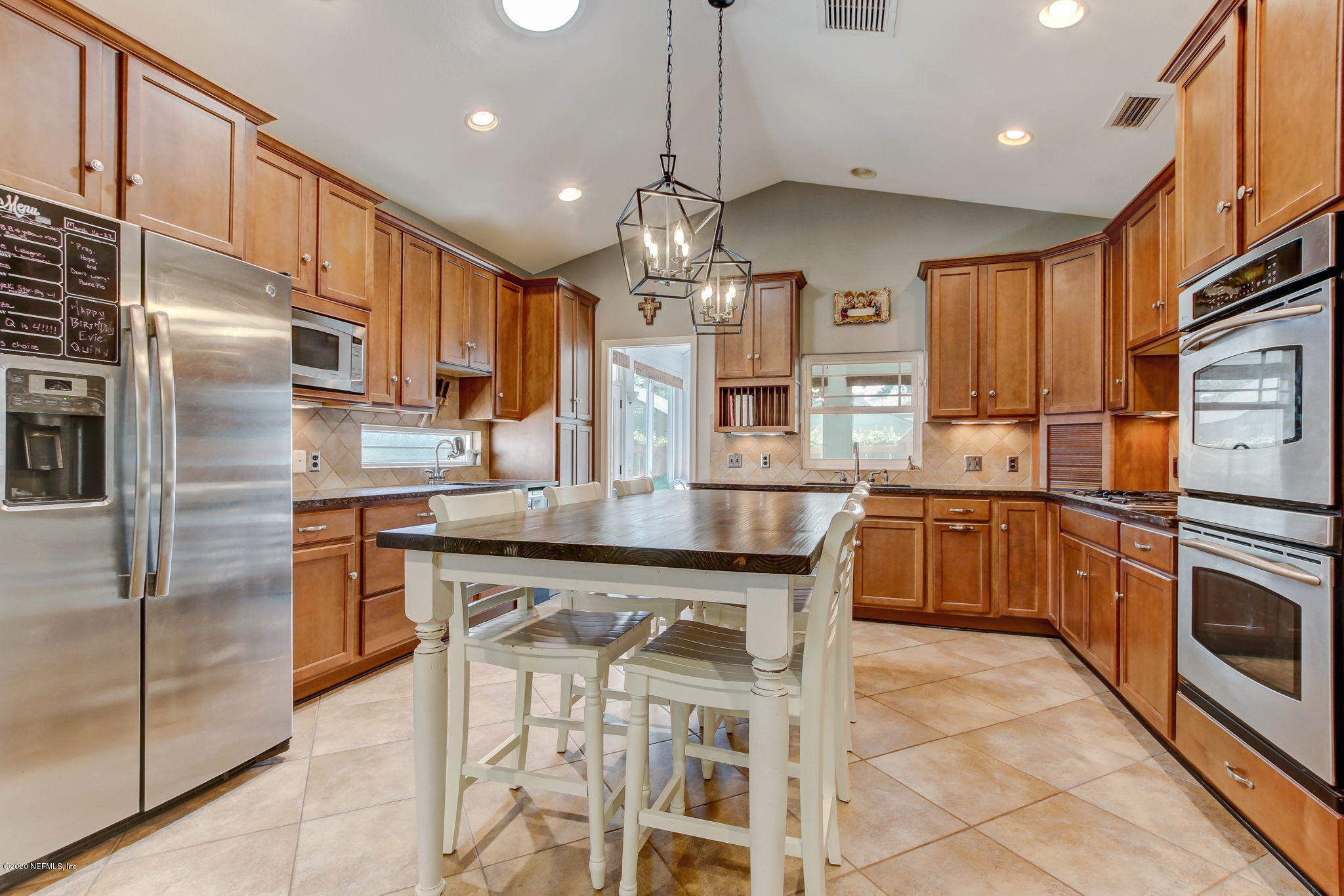 4121 London Road Jacksonville, FL 32207 - Photo 15 of 38 a kitchen with stainless steel appliances granite countertop a sink a stove a refrigerator cabinets and chairs