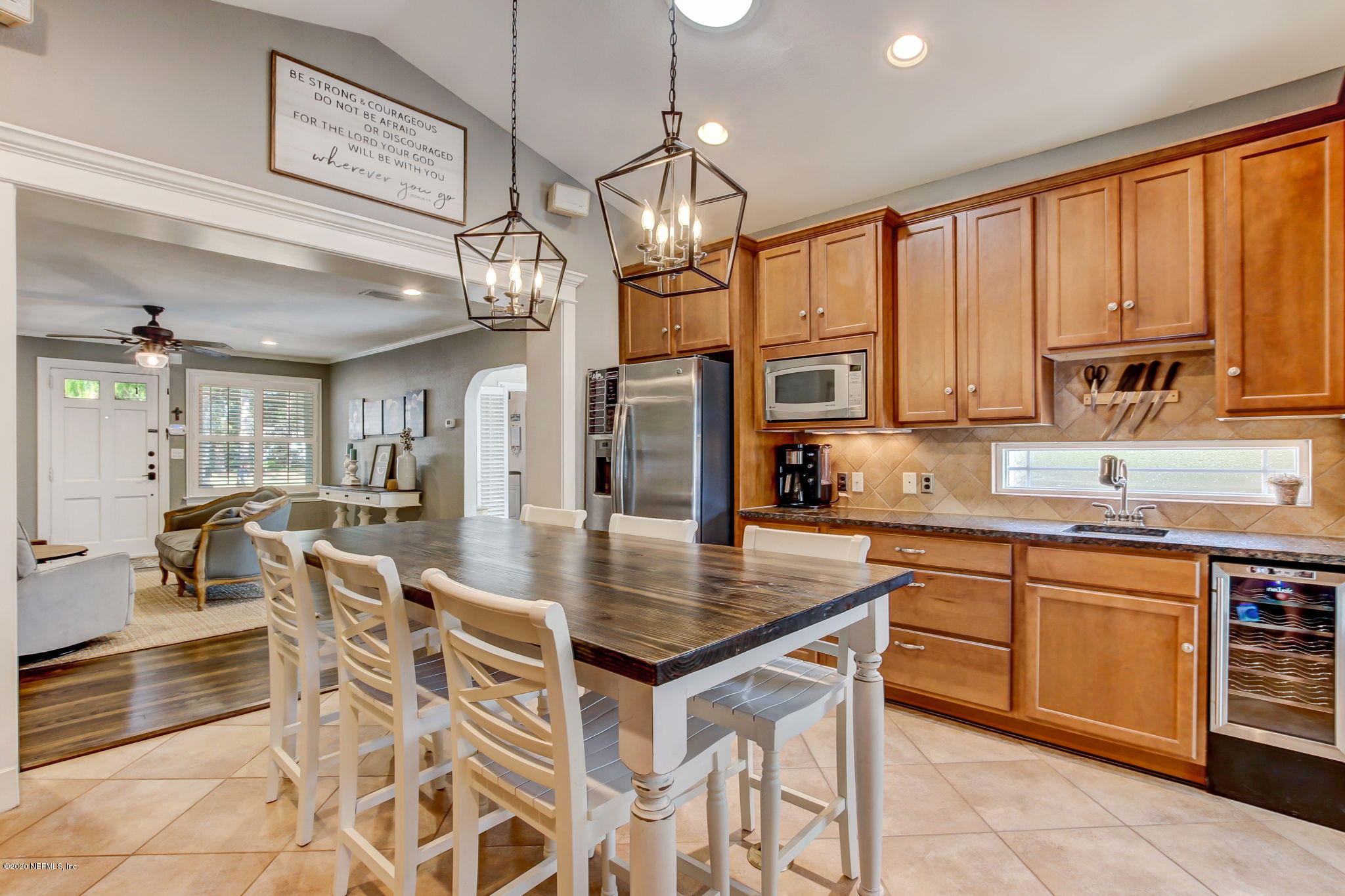 4121 London Road Jacksonville, FL 32207 - Photo 16 of 38 a kitchen with stainless steel appliances granite countertop a stove top oven a sink dishwasher a dining table and chairs with wooden floor