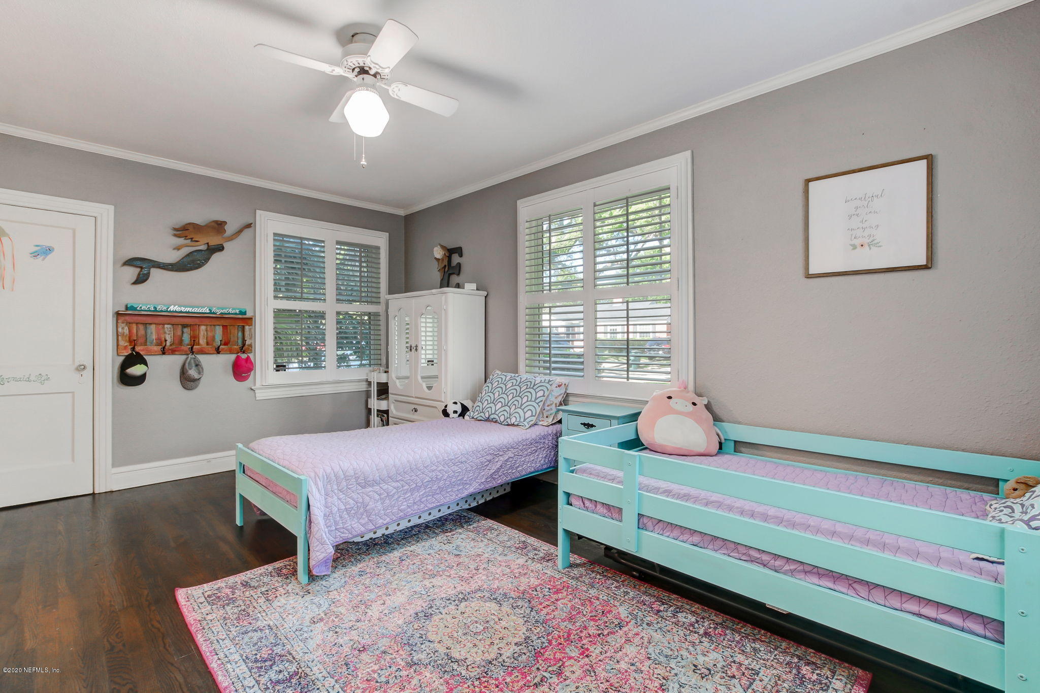 4121 London Road Jacksonville, FL 32207 - Photo 25 of 38 a bedroom with a bed and a chandelier