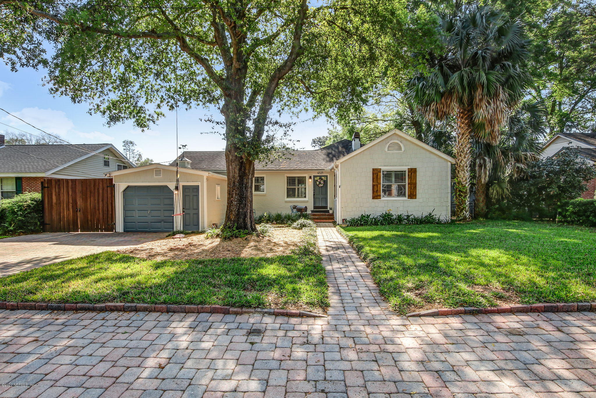 4121 London Road Jacksonville, FL 32207 - Photo 3 of 38 a front view of a house with a garden and yard