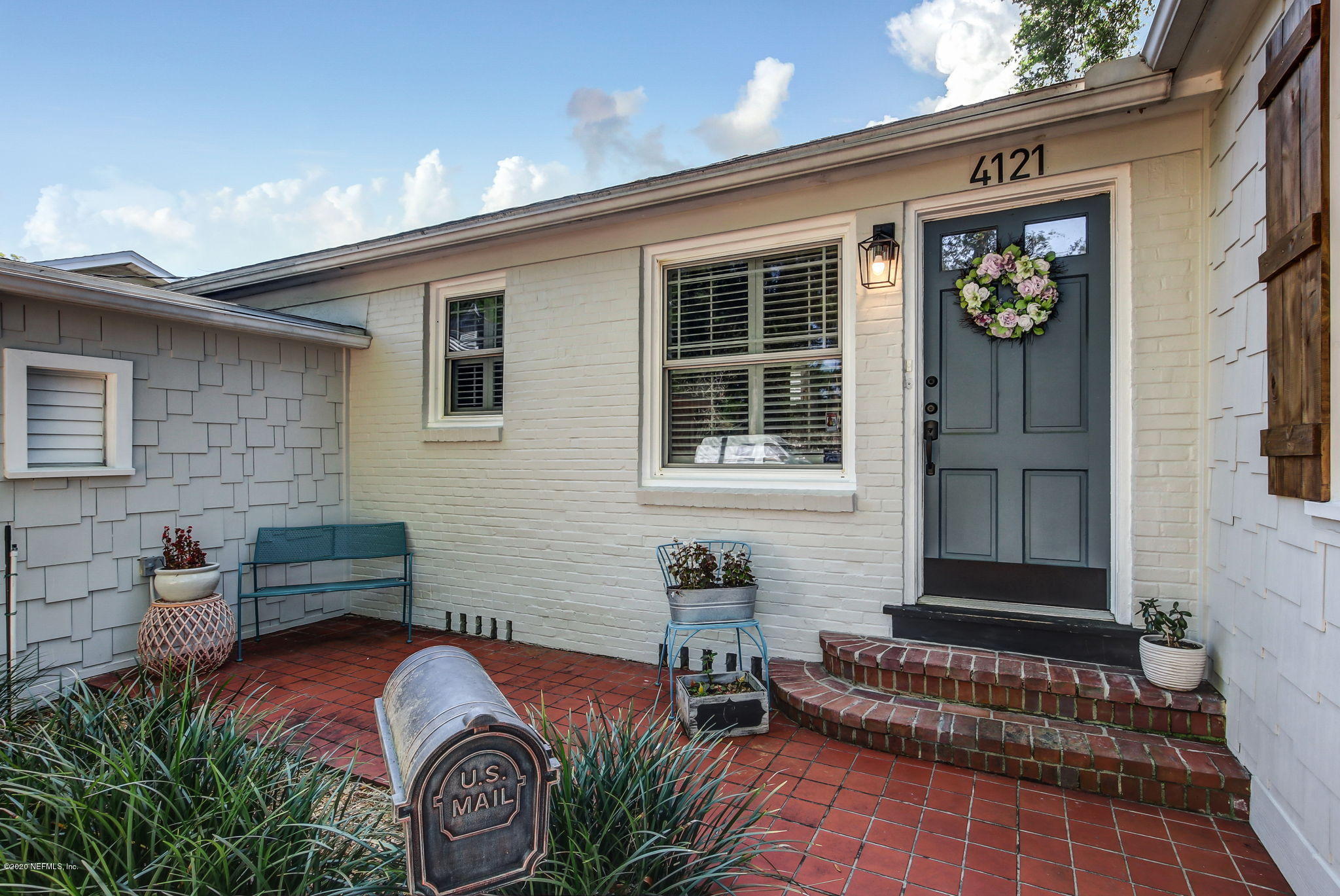 4121 London Road Jacksonville, FL 32207 - Photo 4 of 38 a front view of a house with outdoor seating