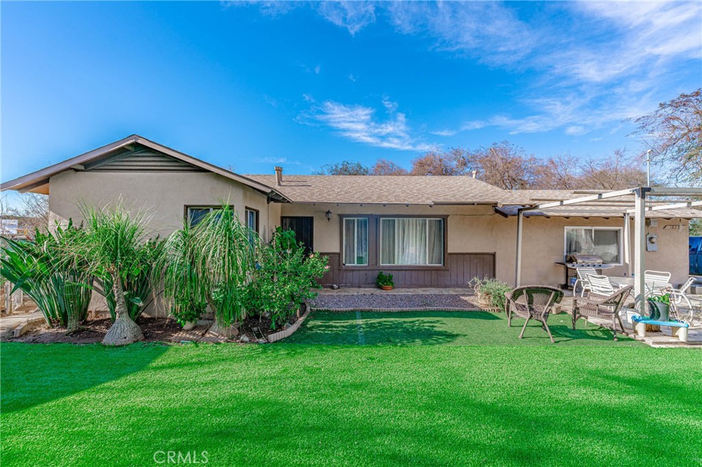 1823 Orange Street Riverside, CA 92501 - Photo 1 of 1 a front view of a house with a yard and outdoor seating