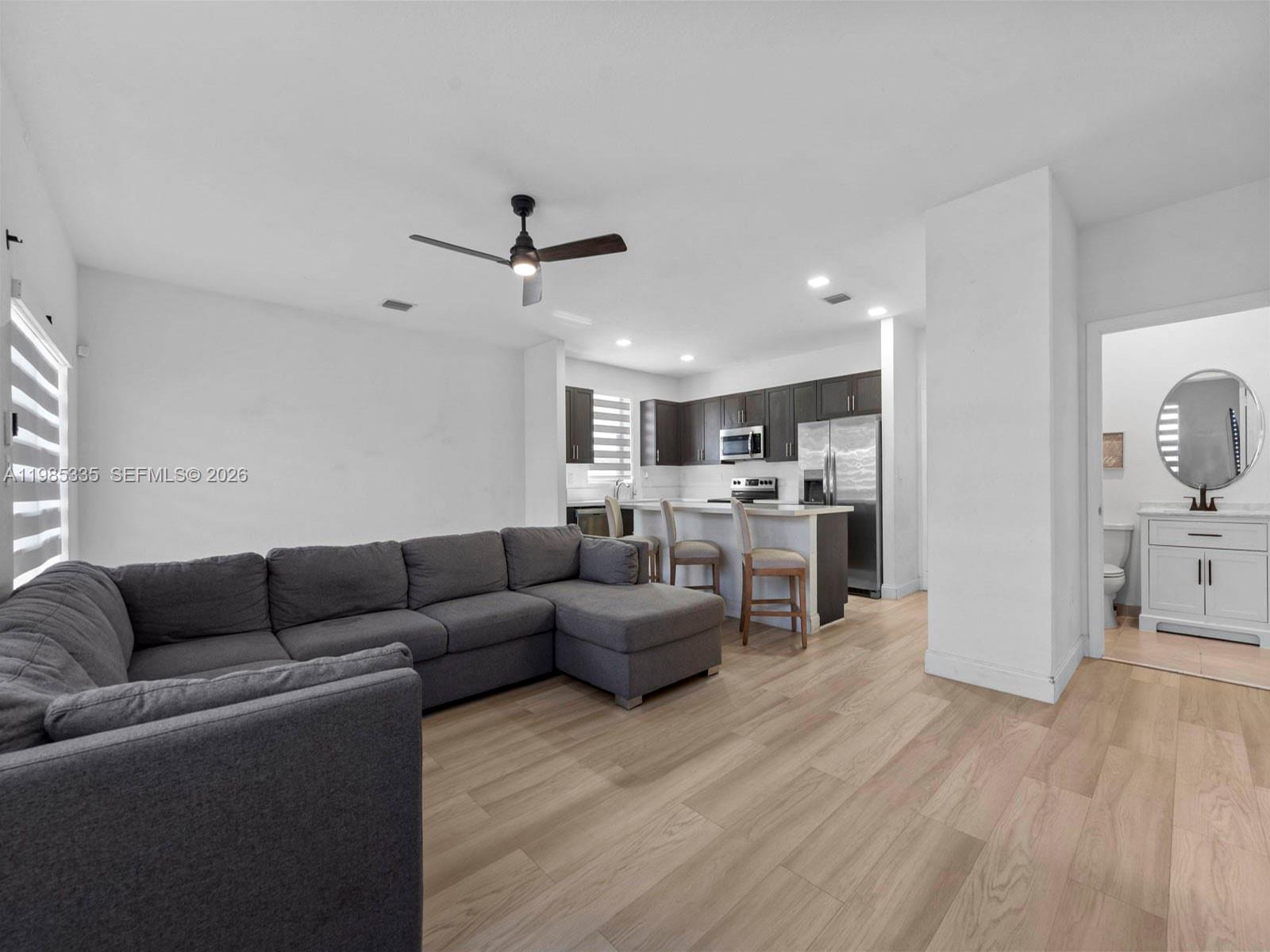 13391 Southwest 285th Street Homestead, FL 33033 - Photo 14 of 37 a living room with furniture and kitchen view