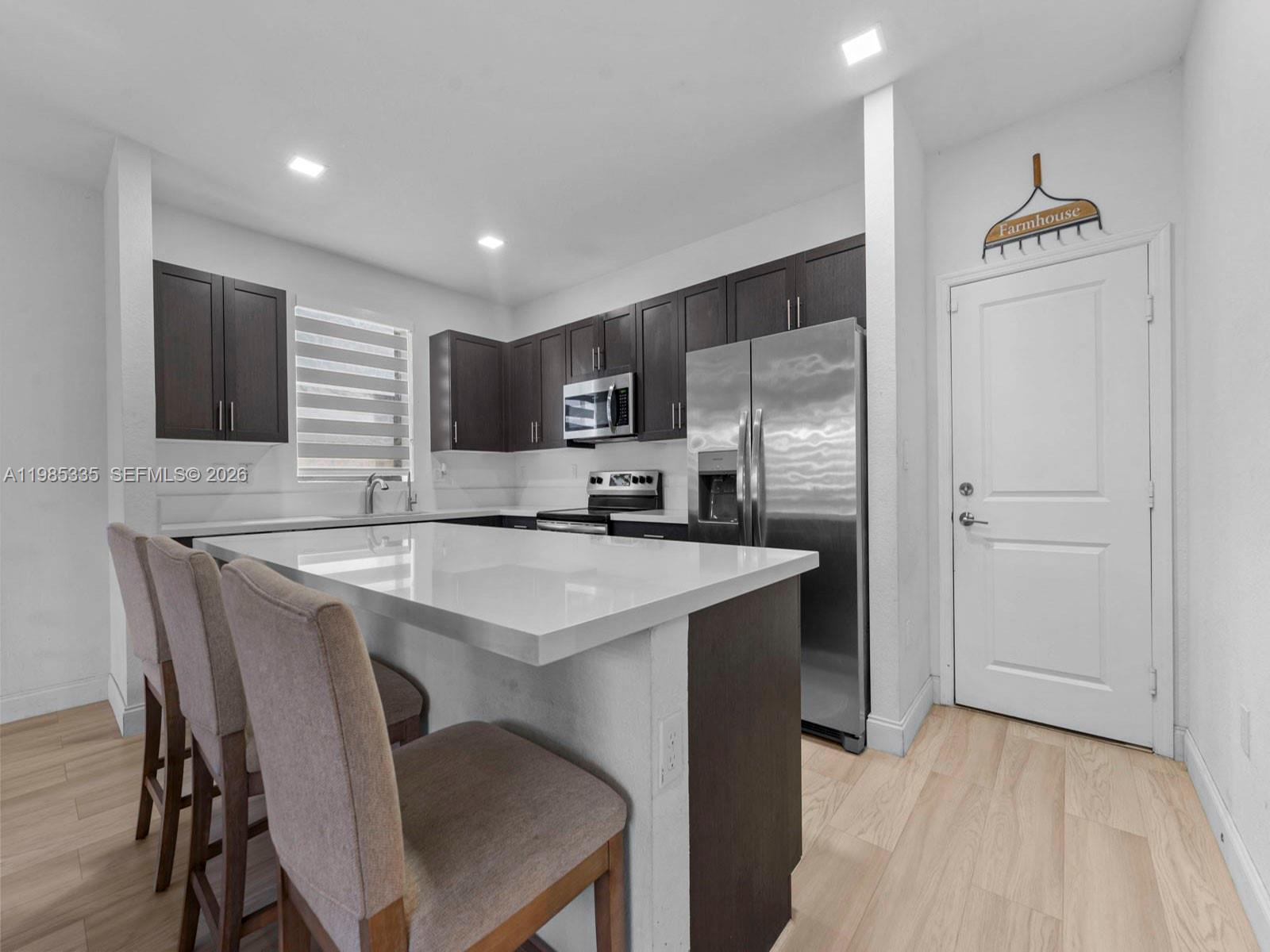13391 Southwest 285th Street Homestead, FL 33033 - Photo 15 of 37 a kitchen with kitchen island a sink appliances and cabinets