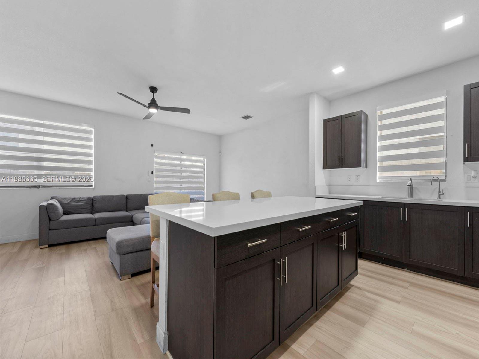 13391 Southwest 285th Street Homestead, FL 33033 - Photo 16 of 37 a kitchen with stainless steel appliances granite countertop a sink counter space and living room