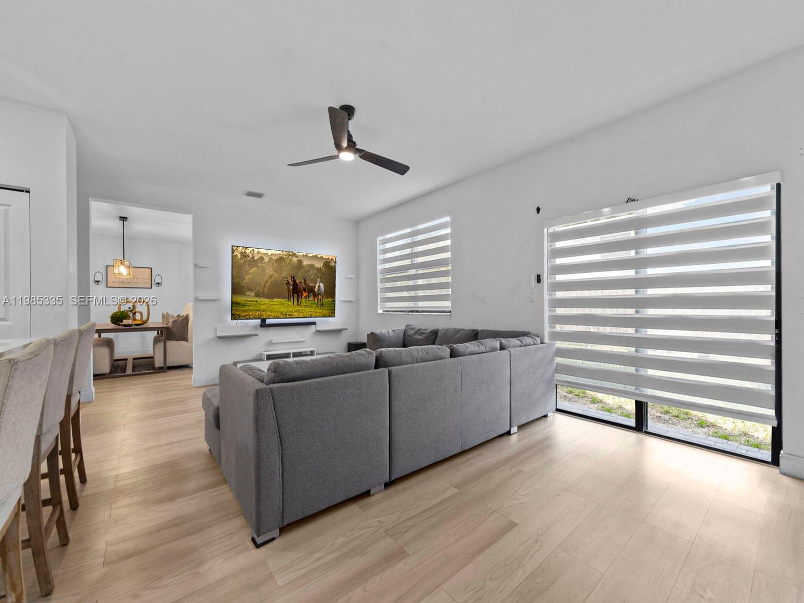 13391 Southwest 285th Street Homestead, FL 33033 - Photo 19 of 37 a living room with furniture and a flat screen tv