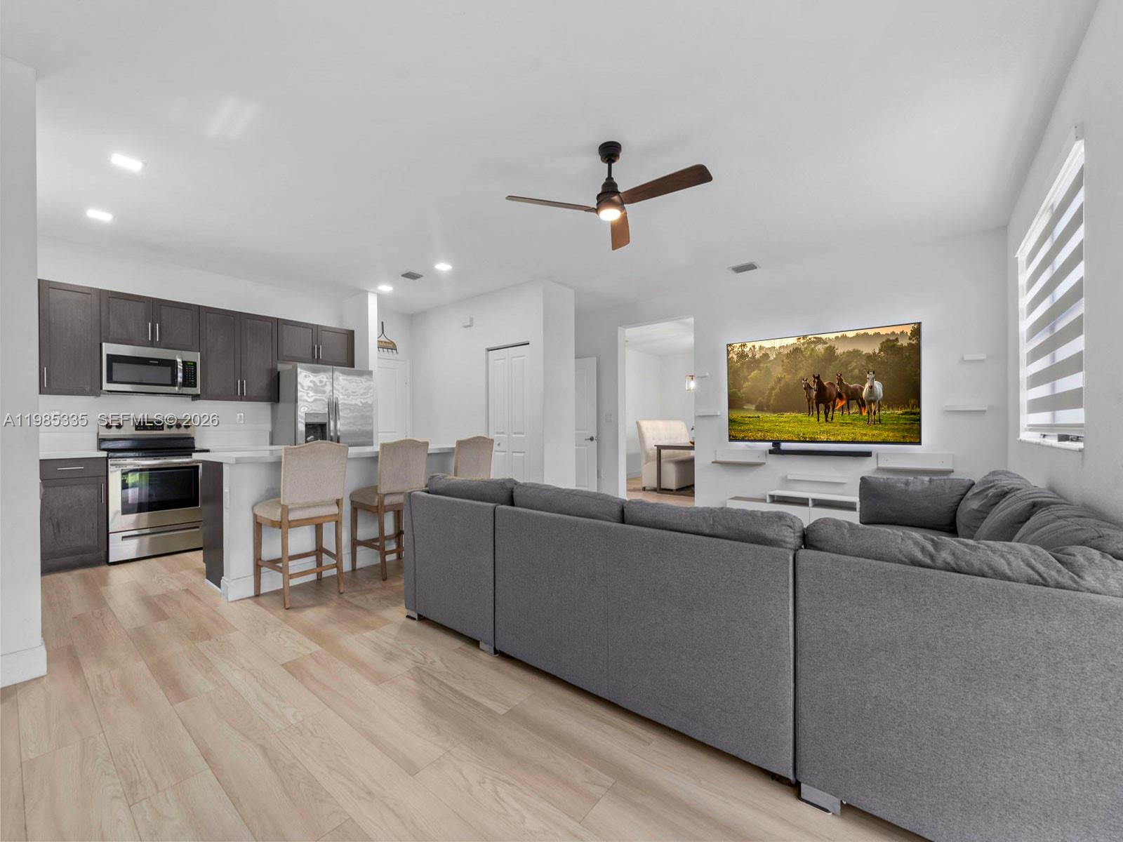 13391 Southwest 285th Street Homestead, FL 33033 - Photo 20 of 37 a living room with furniture and a flat screen tv