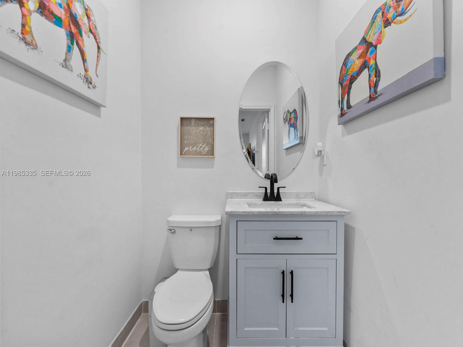 13391 Southwest 285th Street Homestead, FL 33033 - Photo 21 of 37 a bathroom with a toilet a sink and mirror