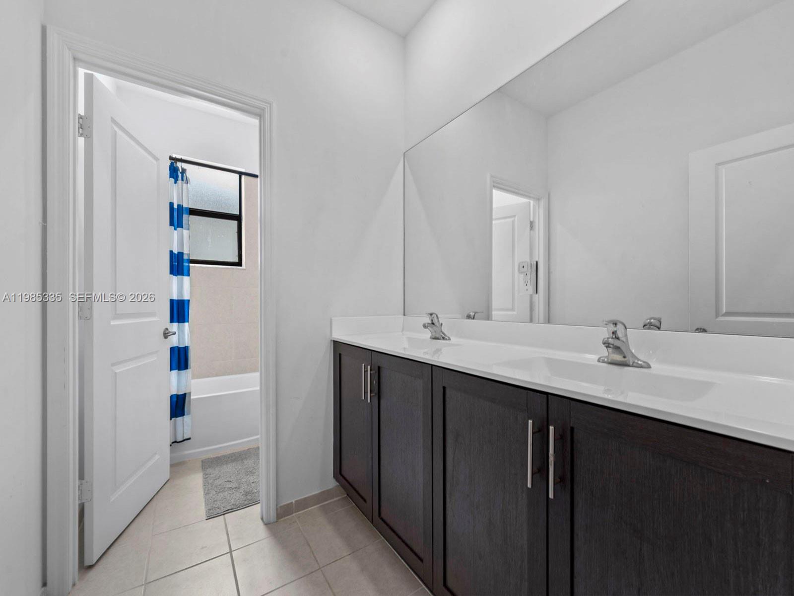 13391 Southwest 285th Street Homestead, FL 33033 - Photo 24 of 37 a bathroom with a double vanity sink and a mirror