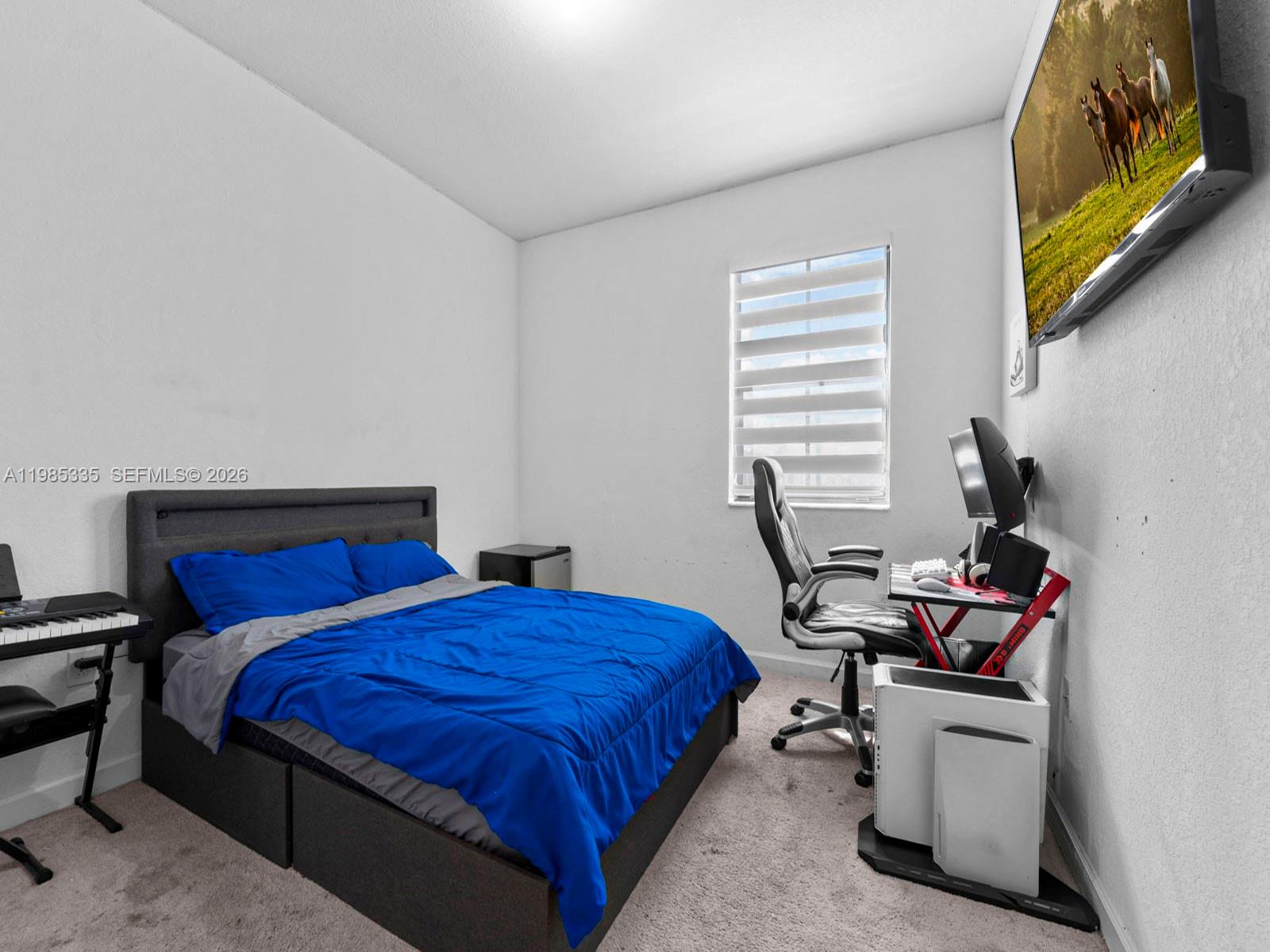 13391 Southwest 285th Street Homestead, FL 33033 - Photo 27 of 37 a bedroom with a bed and a computer on a desk next to a window