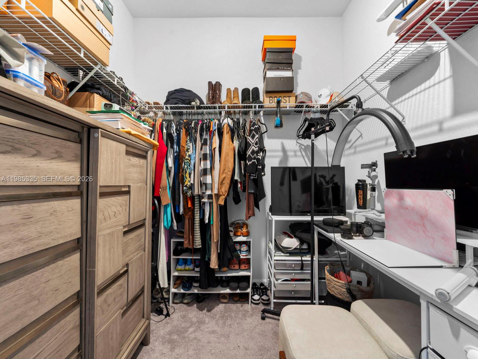 13391 Southwest 285th Street Homestead, FL 33033 - Photo 34 of 37 a view of walk in closet with clothes and shoes