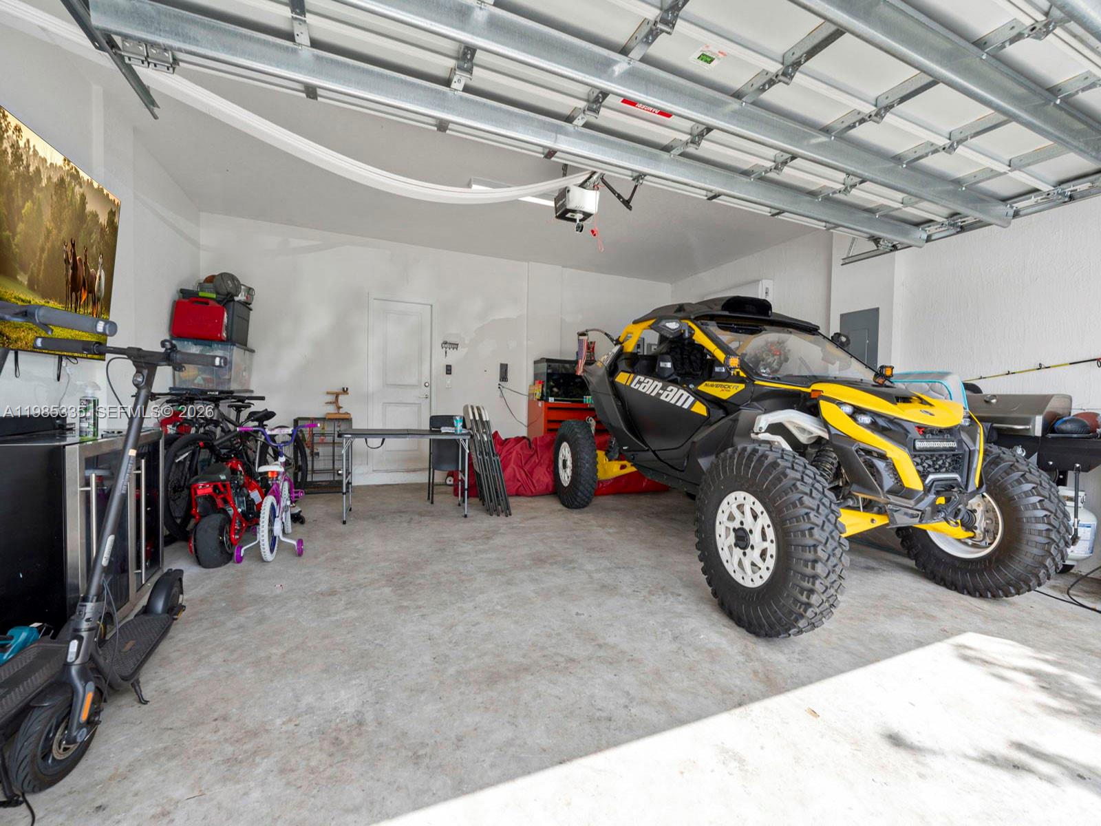 13391 Southwest 285th Street Homestead, FL 33033 - Photo 35 of 37 a view of a garage with a bike and white car