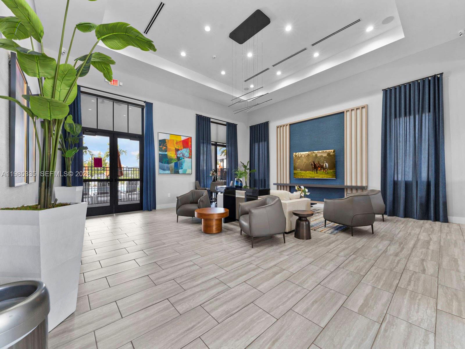 13391 Southwest 285th Street Homestead, FL 33033 - Photo 36 of 37 a lobby with furniture and flat screen tv