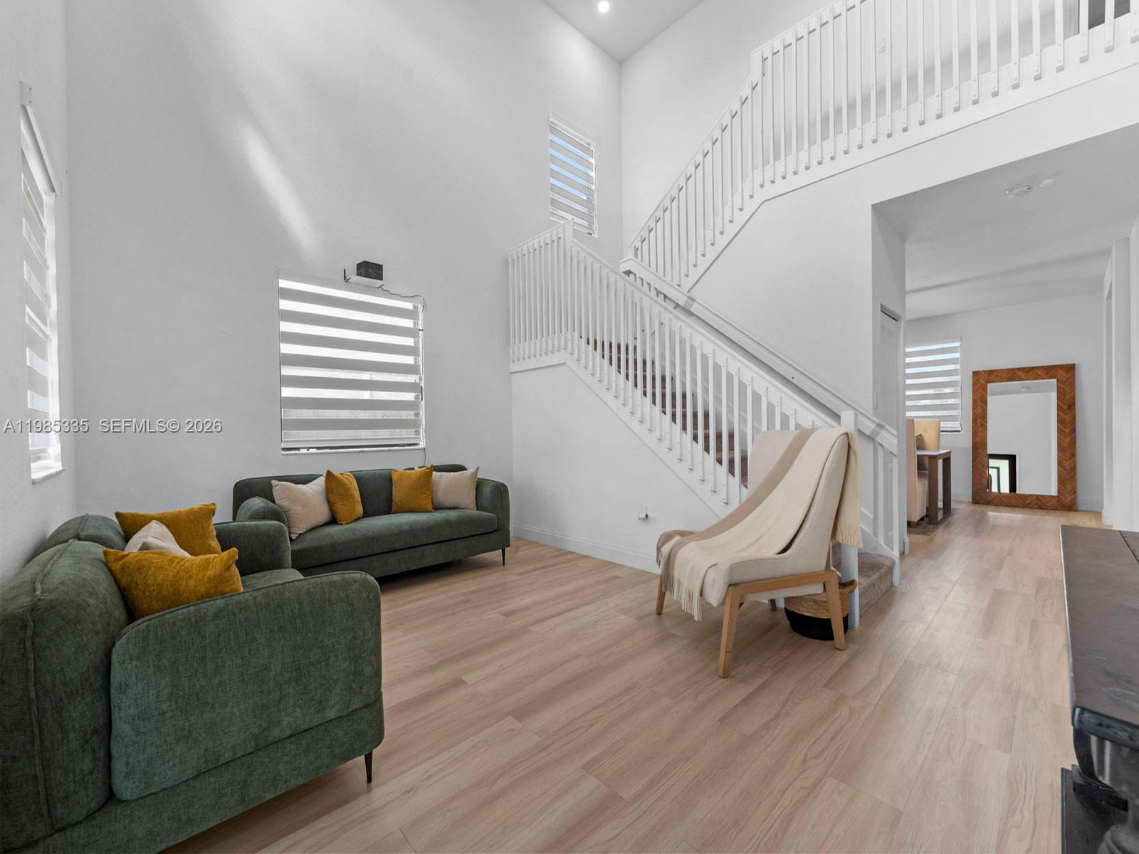 13391 Southwest 285th Street Homestead, FL 33033 - Photo 8 of 37 a living room with furniture and a wooden floor