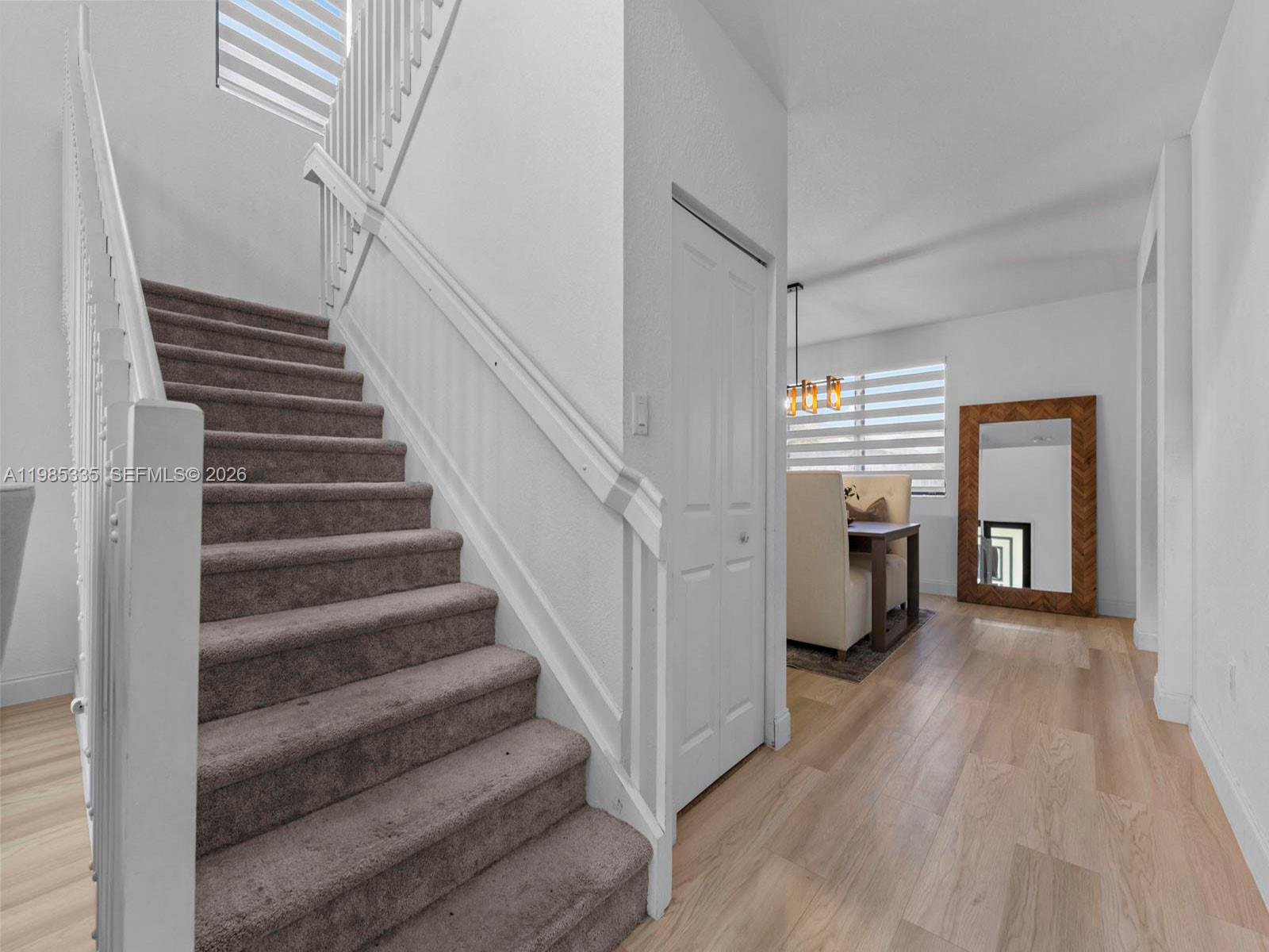 13391 Southwest 285th Street Homestead, FL 33033 - Photo 9 of 37 a view of a hallway with wooden floor and staircase