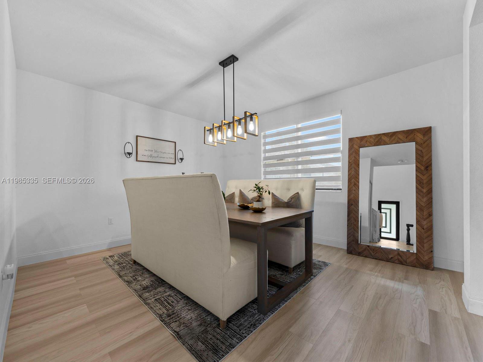 13391 Southwest 285th Street Homestead, FL 33033 - Photo 10 of 37 a living room with table chairs and wooden floor