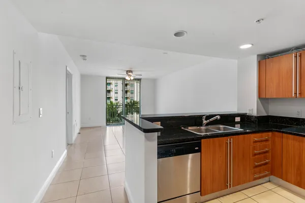 a kitchen with granite countertop a sink and cabinets