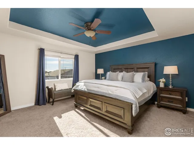 a bedroom with a bed and a night stand