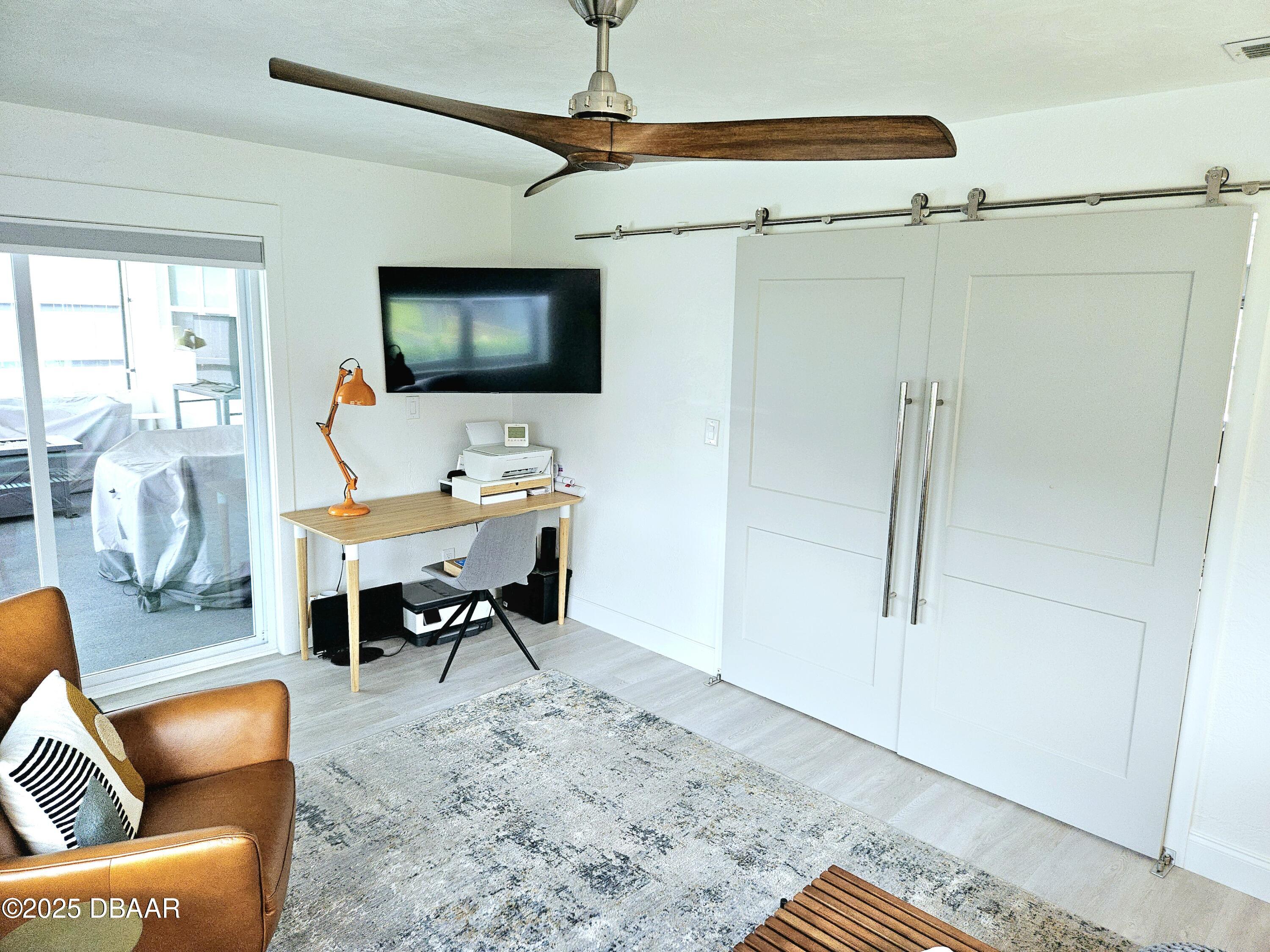 13 Sunrise Avenue Ormond Beach, FL 32176 - Photo 16 of 52 a living room with furniture a flat screen tv and a table