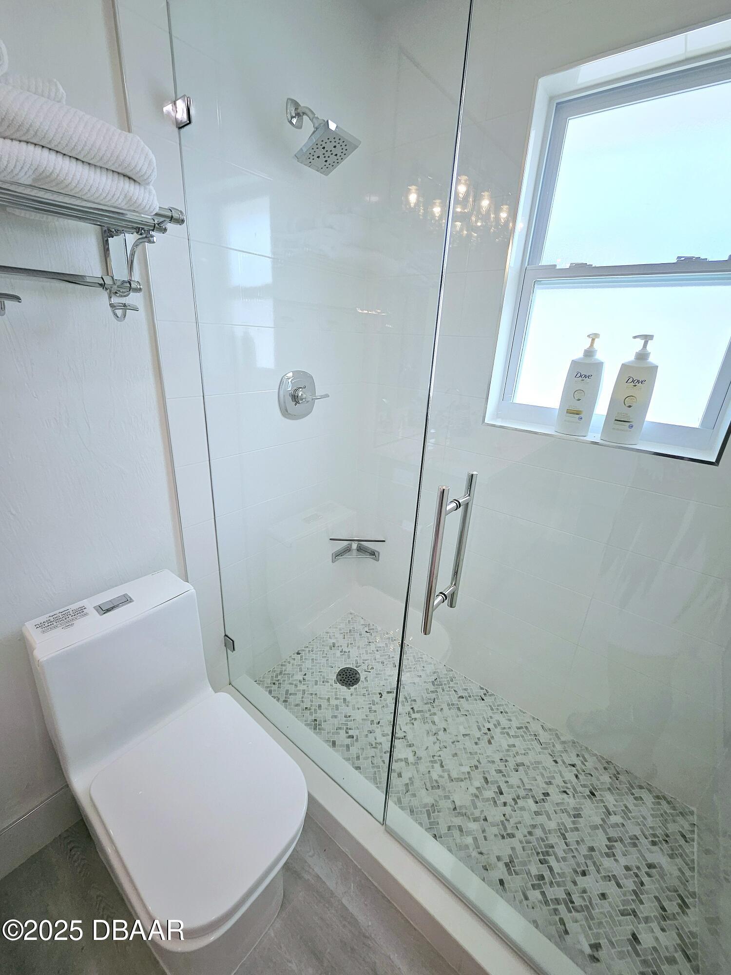 13 Sunrise Avenue Ormond Beach, FL 32176 - Photo 29 of 52 a bathroom with a toilet and a shower