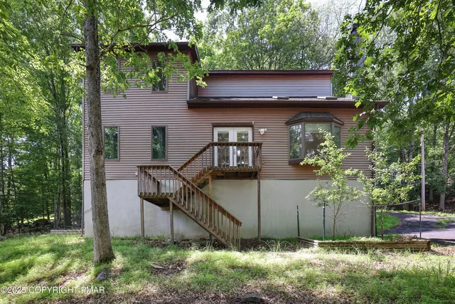 a house that has a tree in front of the house