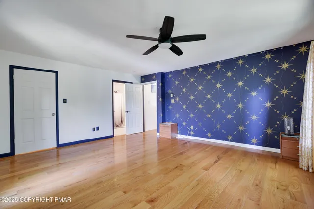 a view of an empty room with wooden floor