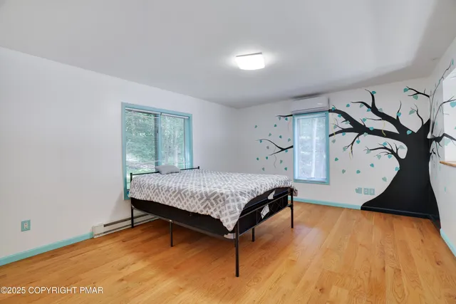 a bedroom with a bed and a dresser