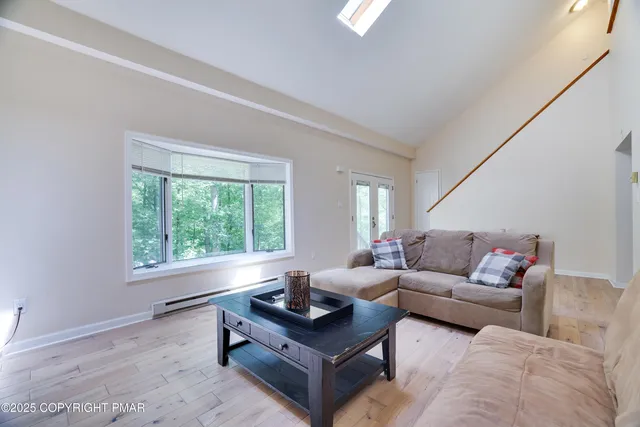 a living room with furniture and a large window