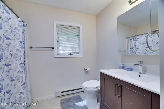 a bathroom with a sink mirror and toilet