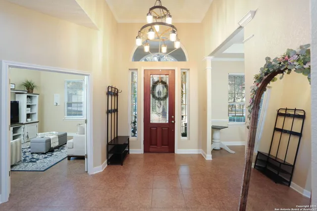 a living room with furniture and a chandelier