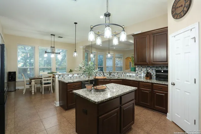 a bedroom with furniture a bed and a chandelier