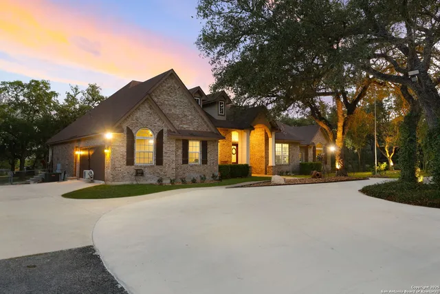a front view of a house with yard and trees