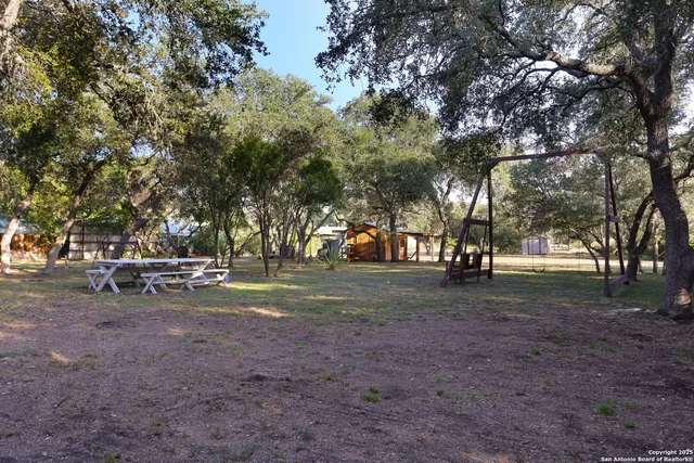 an aerial view of a house with a yard and street