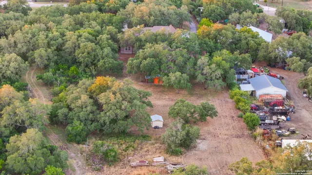 an aerial view of residential house with outdoor space and trees