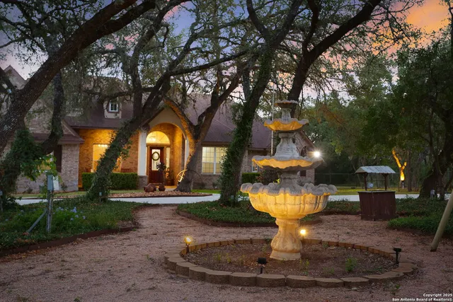 a house with green field in front of it