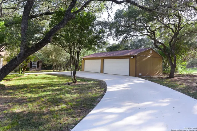 a front view of a house with a yard and trees
