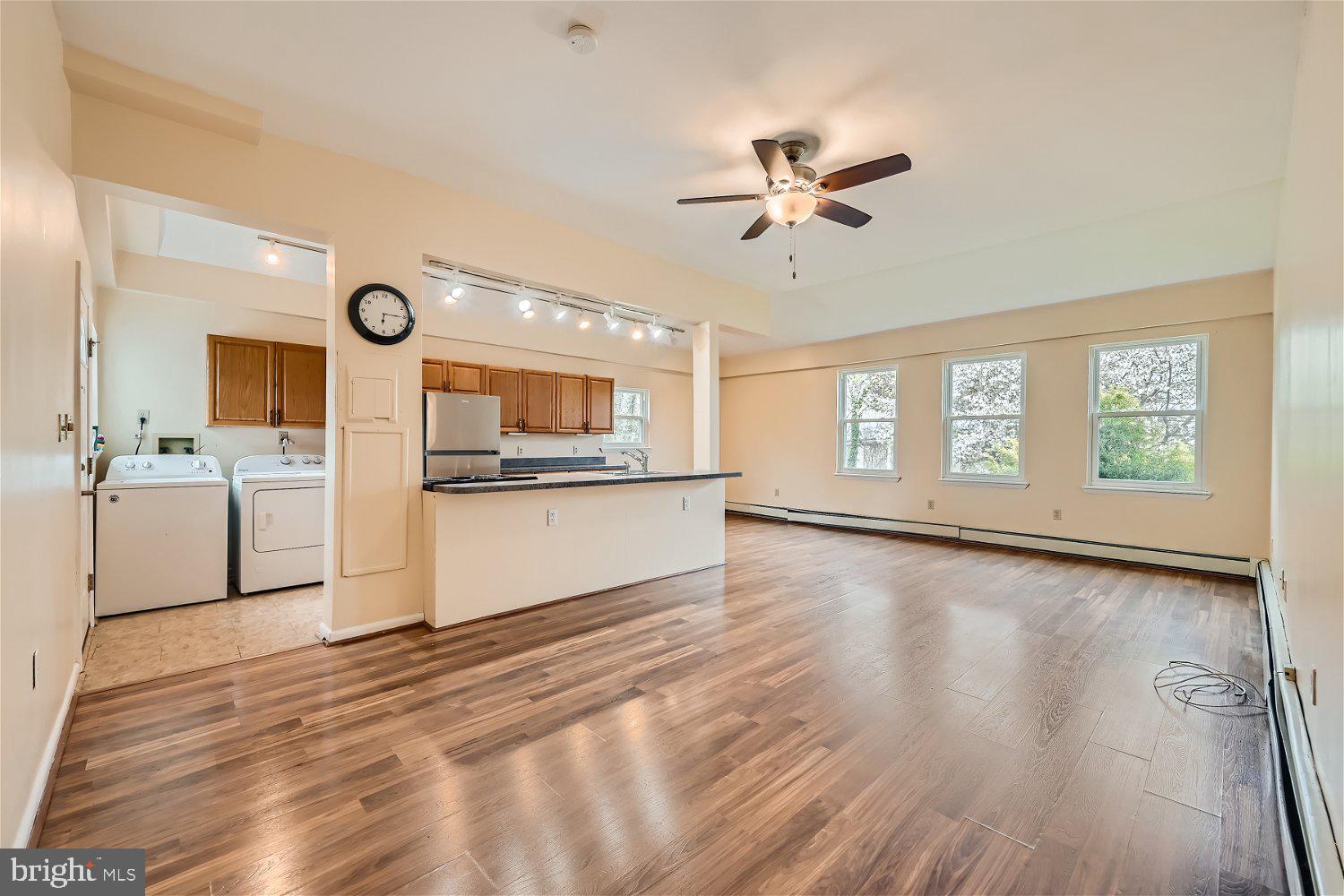 716 South Camp Meade Road, Unit A Linthicum Heights, MD 21090 - Photo 3 of 11 a view of a kitchen with a sink dishwasher a kitchen view with wooden floor and cabinets