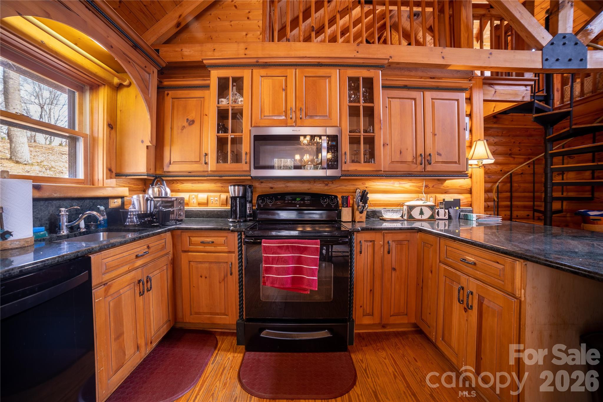 682 Rock House Road Hot Springs, NC 28743 - Photo 12 of 43 a kitchen with stainless steel appliances granite countertop a stove a sink and a refrigerator