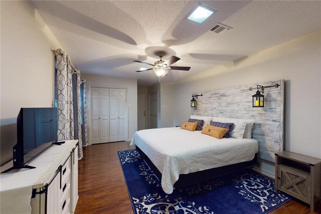 900 Westview Street Bryan, TX 77802 - Photo 16 of 30 a bedroom with a bed and a flat screen tv