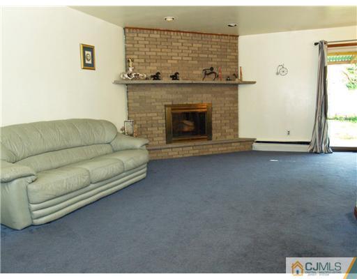 28 Stiles Road Edison, NJ 08817 - Photo 2 of 25 a living room with furniture and a fireplace