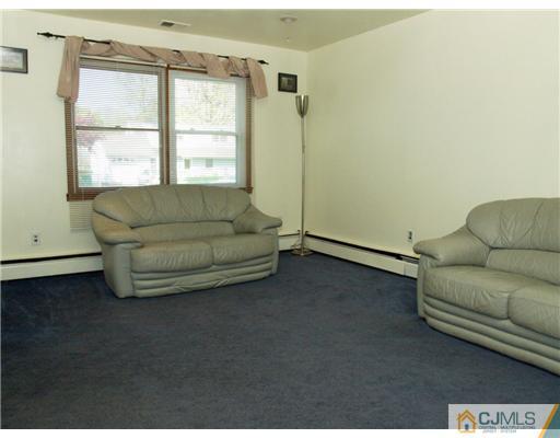 28 Stiles Road Edison, NJ 08817 - Photo 13 of 25 a living room with furniture and a window