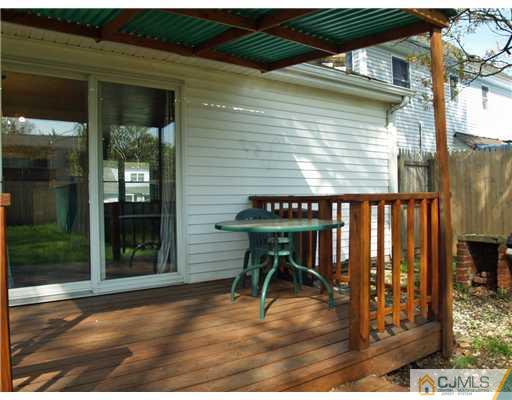 28 Stiles Road Edison, NJ 08817 - Photo 18 of 25 a backyard of a house with table and chairs