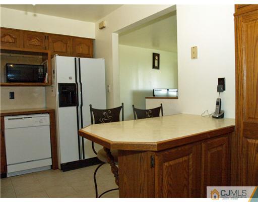 28 Stiles Road Edison, NJ 08817 - Photo 19 of 25 a kitchen with stainless steel appliances a refrigerator and a stove top oven