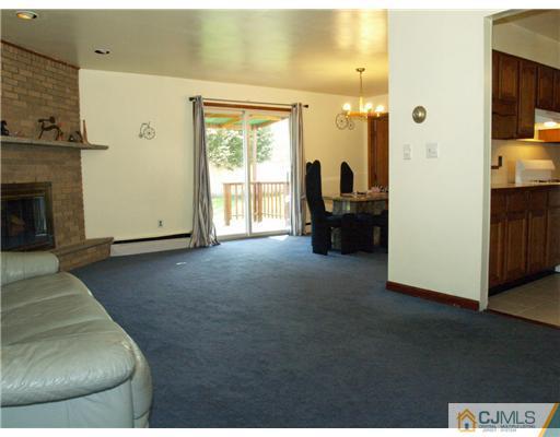 28 Stiles Road Edison, NJ 08817 - Photo 20 of 25 a living room with furniture and a fireplace