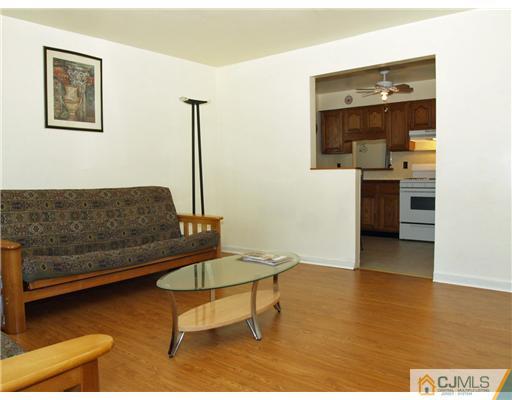 28 Stiles Road Edison, NJ 08817 - Photo 23 of 25 a living room with furniture and a table